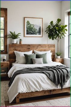 a bed with white sheets and pillows in a bedroom next to a potted plant