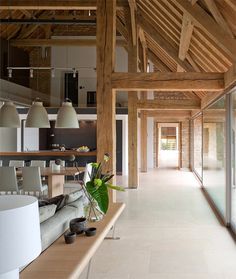 an open floor plan with white walls and wooden beams on either side of the room