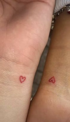 two people with small tattoos on their arms