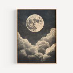 an image of the moon above clouds on a black and white background framed in wood frame