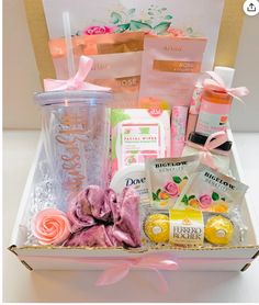 a pink gift box filled with lots of goodies for someone's special occasion