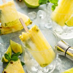 two glasses filled with lemonade and limeade ice cream on top of ice cubes