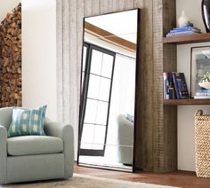 a living room filled with furniture and a large mirror