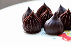 four pieces of chocolate sitting on top of a plate