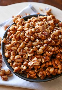 a bowl filled with nuts sitting on top of a table