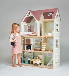 A large open-fronted doll house scaled for 25cm dolls. Beautiful contemporary soft colours and detailed illustrations make this house truly unique as well as premium. The gabled roof and attic space, opening shutters and front door, and with windows on the back panel allow light to flood into trhe spacious interior. Access to the balcony on the second floor gives extra interest and space to play. On the ground floor; The walls are decorated to resemble a kitchen area Table and 2 chairs, 2 mugs, Home Made Dollhouse, Michaels Dollhouse Castle, Dolls House Uk, Front Door With Windows, Open Shutters, Gabled Roof, House Unique, Wooden Play Kitchen, Attic Space