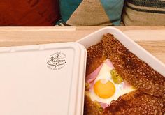 an egg in a toasted bread box on a table