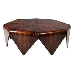 a wooden table with three triangular shaped legs