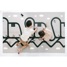 two children are playing on the wall with toys