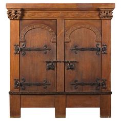 an old wooden cabinet with ornate carvings on the front and sides, isolated against a white background