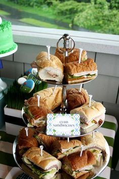 a tiered tray with sandwiches on it