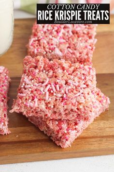 cotton candy rice krispie treats on a cutting board next to a glass of milk