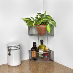 two metal baskets holding plants and bottles on a counter