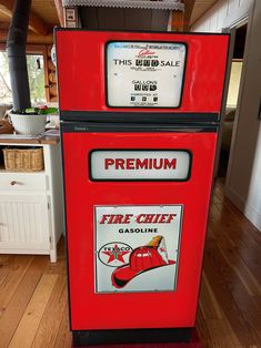 an old fashioned fire chief vending machine in a kitchen with wood floors and white walls