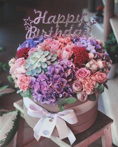 a birthday cake with flowers in a flower pot