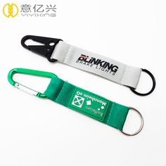 two lanyards, one green and the other white with an emblem on it