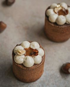 two small brown baskets filled with food on top of a table