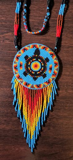 a beaded necklace on a wooden table