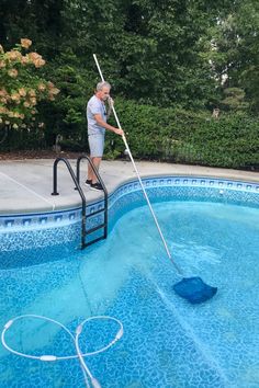 a man cleaning the pool with a mop