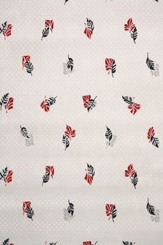 a white background with red and black leaves on the bottom half of it, which is dotted in polka dots