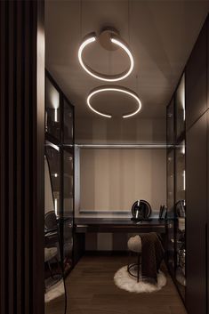 a room with a desk and some lights on the ceiling in front of a mirror