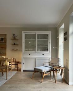 a living room filled with furniture next to a wall covered in bookshelves and shelves