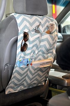 a car seat covered in a blue and white chevron pattern with sunglasses on it