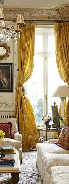 a living room filled with furniture and a chandelier