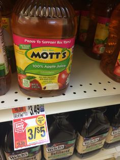 bottles of mott's apple juice are on the shelf in a store aisle