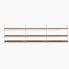 three wooden shelves with metal brackets on each side and one shelf holding two bookshelves