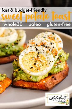 two pieces of toast with avocado and an egg on top are sitting on a plate