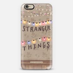 a phone case with lights and the words strange things on it