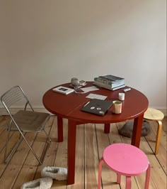 a small table with two chairs next to it and a book on top of the table