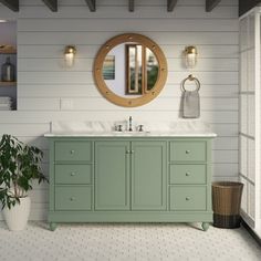 a bathroom with a sink, mirror and potted plant on the floor in front of it