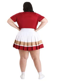 a woman in a red shirt and white skirt with her back turned to the camera