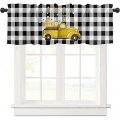 a window with a black and white checkered valance that has a yellow truck on it