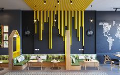 the interior of a restaurant with yellow and black decorations on the walls, tables and benches