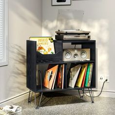 an old record player sits on top of a bookcase