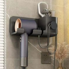 a wall mounted hair dryer on the side of a shower stall with a blow dryer attached to it