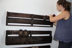 a woman using a drill to paint a wooden bench