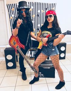 two people are dressed up as rock band members, one holding an electric guitar and the other wearing fishnet stockings