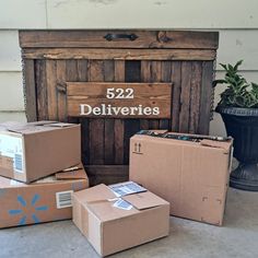 several boxes are stacked on top of each other in front of a mailbox with the number 522 delivered