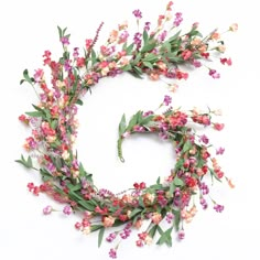 the letter c made out of flowers and leaves