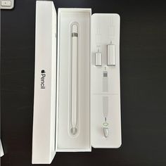 an apple watch in its box next to it's charger and power cord