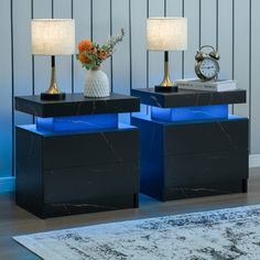 two black and blue side tables with lamps on them