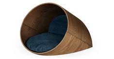 a wooden chair with a blue cushion in the shape of a pod shaped like an egg