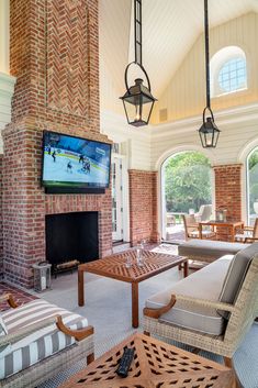 a living room filled with lots of furniture and a flat screen tv mounted to the wall