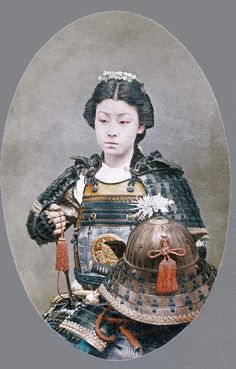 an old photo of a woman wearing armor and holding a helmet on her lap,