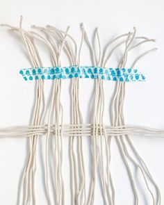 several pieces of white string with blue dots on them