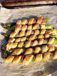 asparagus wrapped in bread on top of parchment paper